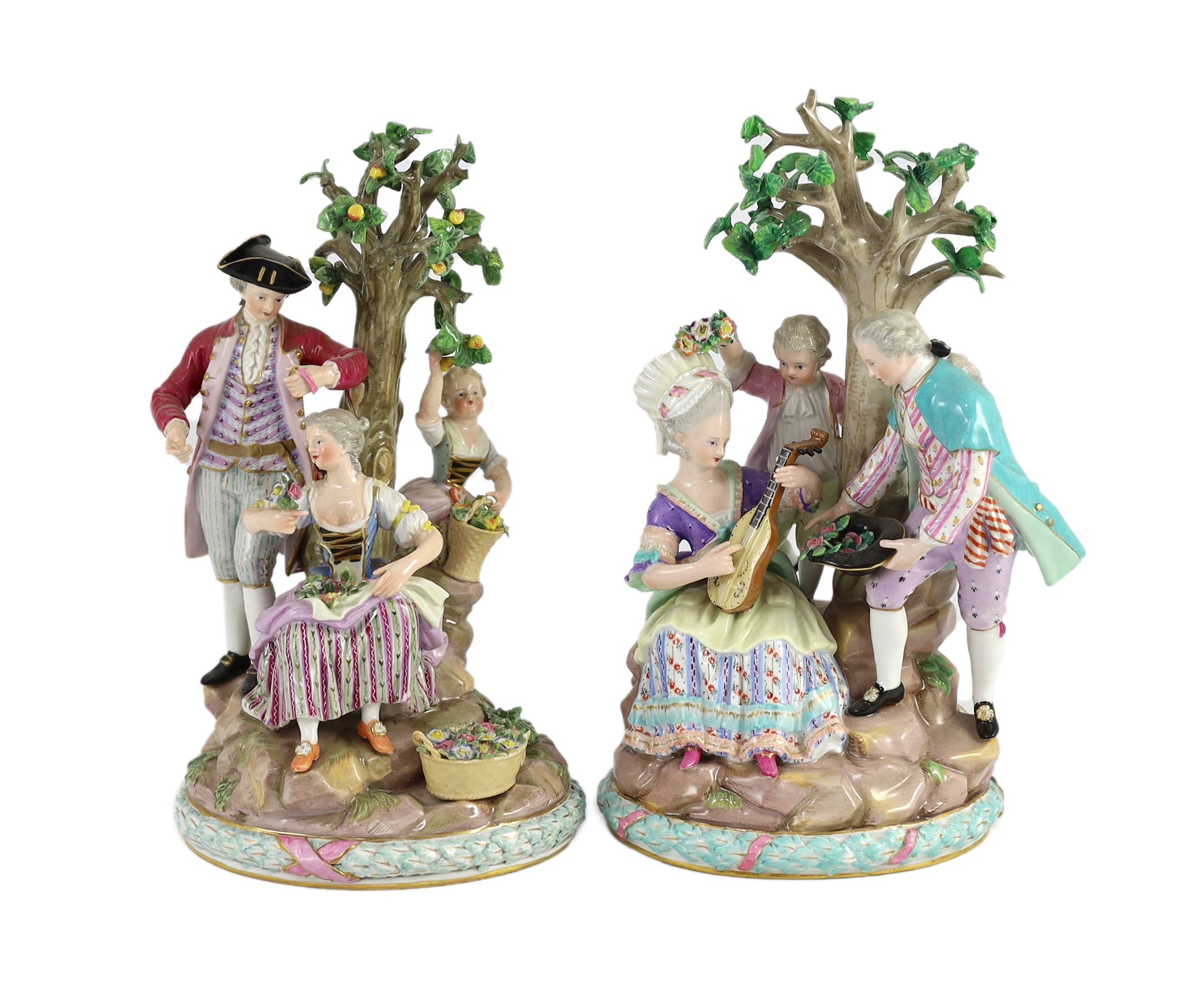 A pair of Meissen groups of apple pickers and flower gatherers, 19th century, 26cm and 27.5cm high